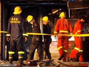 Rescue officials survey the scene of the nightclub fire in Bangkok, Thailand.
