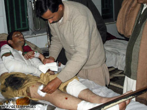 A paramedic treats a victim of a suicide blast at a hospital in Dera Ismail Khan on Sunday.