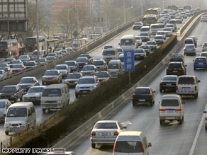 Commuters drive along a road in downtown Beijing, China, on Thursday.