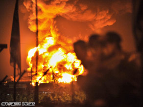 People watch a fire at Jakarta's lone fuel depot on Sunday.