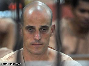 Harry Nicolaides behind the bars of a Thai holding cell on Monday.
