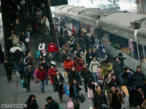 Passengers crowd a railway platform in Beijing as New Year holiday migrations get underway.