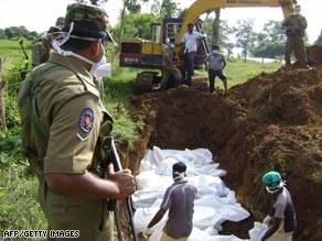 Sri Lankan workers bury the bodies of some 38 suspected Tamil Tiger rebels killed in recent fighting.