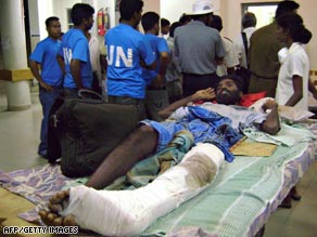 A civilian, injured during fighting in rebel territory, lies on a bed at a hospital in Vavuniya.