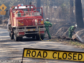 A fire crew douses hotspots on the edge of Healesville, north of Melbourne.