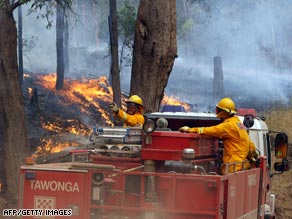 Firefighters try to stop a Kiewa Valley fire from reaching the town of Dederang in the Victoria Alps on Tuesday.
