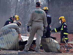 Forensic teams sift through the remains of a house in Pheasant Creek, north of Melbourne.