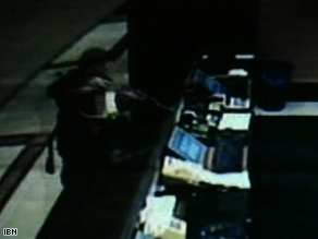 A surveillance video appears to show a gunman shoot at a desk in the Hotel Trident in November.