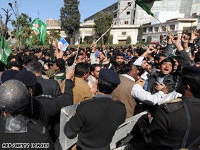 Pakistani policemen struggle with supporters of former premier Nawaz Sharif in Rawalpindi.
