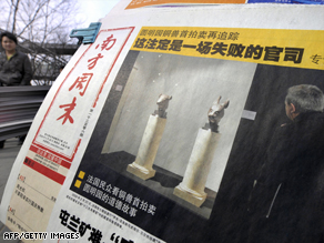 A Beijing news stand shows a report about the sale of the two bronze artifacts.
