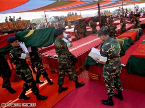 Bangladeshi soldiers carry a coffin during a funeral Monday for victims of last week's mutiny.