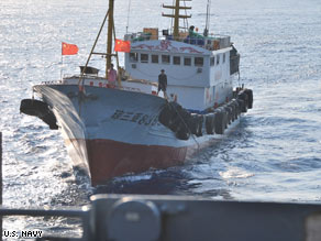 The Navy says this shows a trawler crew member using a hook to try to snag the Impeccable's towed acoustic array.