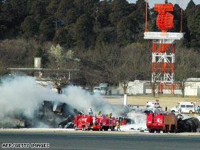 Smoke rises from a FedEx cargo plane that crash landed on the tarmac of the Narita International Airport, Tokyo.