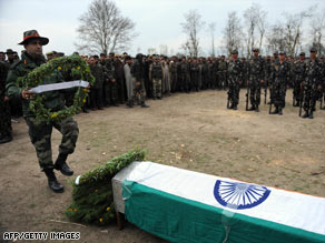 An Indian army soldier lays a wreath during the funeral of a slain soldier, northeast of Srinagar on Tuesday.