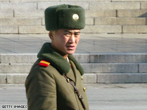 A North Korean soldier stands guard in the border village of Panmunjom on December 1, 2004 in South Korea.