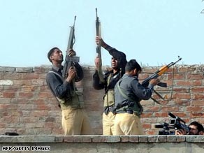 Paramilitary soldiers arrest a suspect near the site of Lahore's police training center.