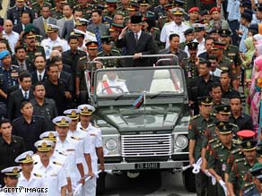 Malaysia's former PM Abdullah Badawi waves from a vehicle in Kuala Lumpur on Friday.