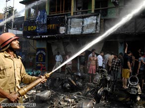 Firefighters attempt to control a fire after an explosion in the Indian city of Guwahati.