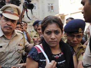Indian police escort lawyer Anjali Waghmare as she leaves her residence in Mumbai on March 31.