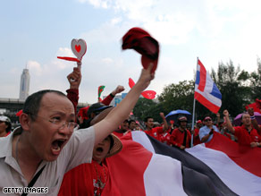 A supporter of former premier Thaksin Shinawatra wearing his mask at a protest in Bangkok.