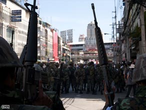 Thai soldiers secure an area early Monday in Bangkok after dispersing protesters.