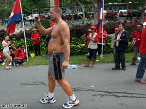 A tourist takes videos of protesters in Bangkok, Thailand.