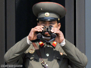 A North Korean soldier looks into South Korea from the demilitarized zone on April 9.