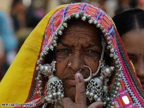 A Lambadi tribal woman shows her ink marked finger after casting her vote at Rangareddy District on April 16.