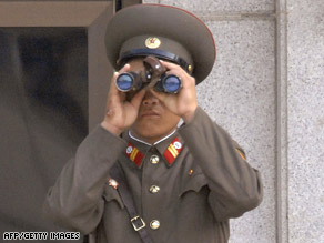 A North Korean soldier scans the southern side of the border at Panmunjom along the Demilitarized Zone.