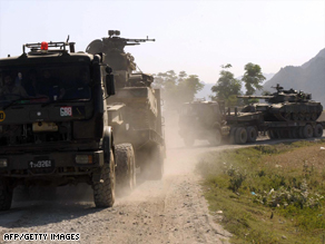 Pakistani army trucks move military equipment into the troubled Buner district Thursday.