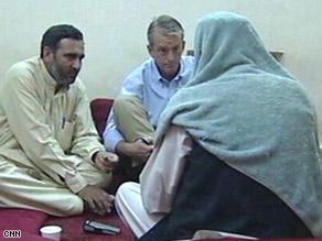 CNN's Nic Robertson, center, talks to Taliban spokesman Zabiullah Mujahid, right, at an undisclosed location.