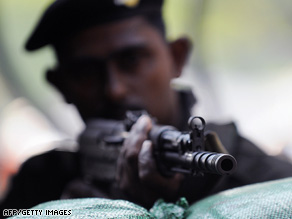A Sri Lankan soldier guards a military checkpoint last week in the capital of Colombo.