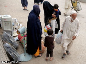 People arrive in Rawalpindi from Swat district, Tuesday. Many have fled suburban areas in the town of Swat.