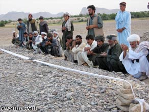 Villagers pray at a mass grave this week after an airstrike in  Afghanistan's Farah Province.