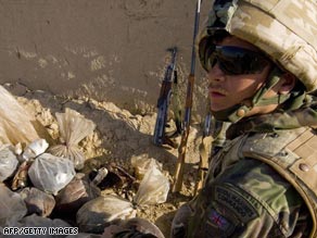 A British marine with an opium haul in Helmand province, where the four soldiers were killed.