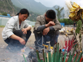 At Beichuan school, parents and relatives give offerings for their dead child.