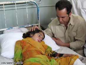 CNN's Reza Sayah with Shaista, who lost most of her family in an explosion as they fled fighting.