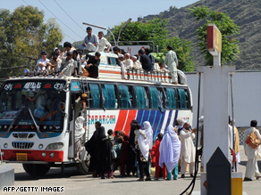 Pakistani civilians pack a bus leaving Mingora, the capital of the troubled Swat Valley.