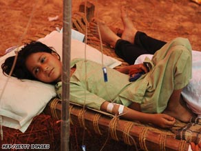 A Pakistani girl displaced by the military's offensive against the Taliban rests at a camp Saturday north of the capital.