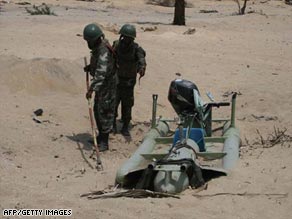 Sri Lanka's defense ministry says this handout photo shows troops with a captured Tamil Tiger craft Thursday.