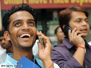 Onlookers outside the stock exchange in Mumbai Monday watch share prices surge following the election results.