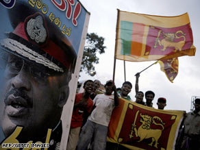 A crowd beside a portrait of Sri Lanka's president celebrate the country's military victory on May 18.