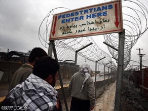 Afghan workers enter a walkway on March 3, 2009, at Bagram Air Base, Afghanistan.