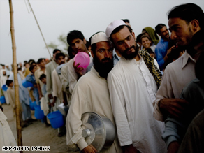 Displaced civilians line up for a meal at Chota Lahore camp in Swabi district.