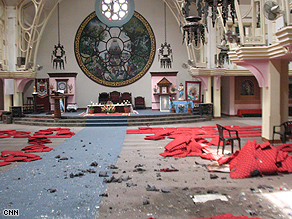 Police with sniffer dogs investigate the scene of a blast at a church in Kathmandu.