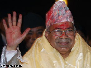 Madhav Kumar Nepal waves at his supporters at the country's parliament in Kathmandu.