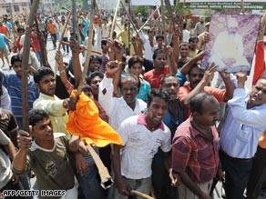 Sikh demonstrators brandish sticks as they shout slogans during a protest in Amritsar.