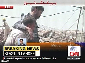 An injured man is helped at the site of the blast.