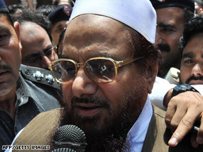 Pakistani police escort Hafiz Saeed outside court after a hearing in Lahore in May.