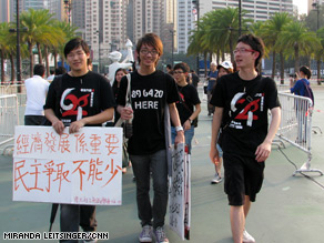 Students hold signs calling for democracy in China and better education aboutTiananmen in Hong Kong.